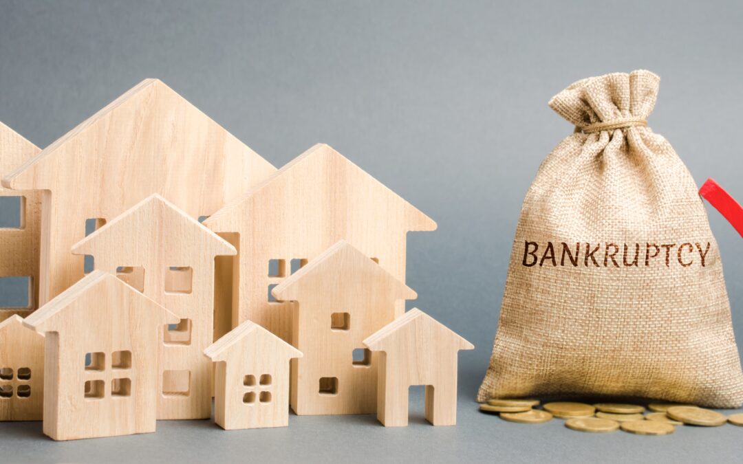 a-money-bag-with-the-word-bankruptcy-a-down-arrow